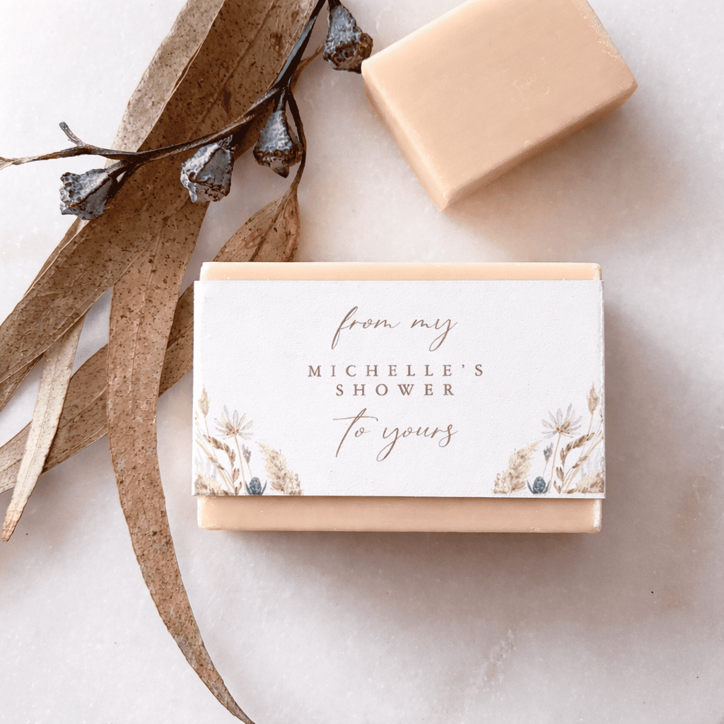 Printed belly bands wrapping handmade soap bars with branded artwork and ingredient details